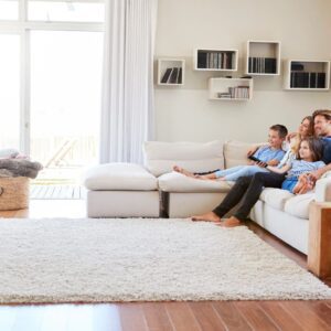 A family sitting on the couch in their living room